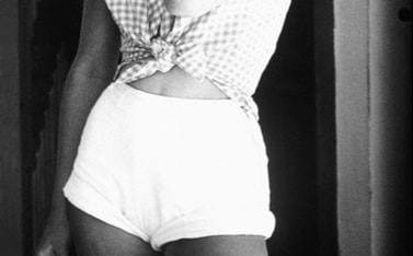  Elegant style icon wardrobe essentials: A pair of high-waist shorts; Romy Schneider in a pair of high waist shorts