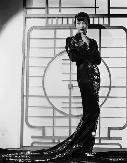 Anna May Wong wearing Black sequined gown with dragon motif in film Limehouse Blues, designed by Travis Banton, 1934