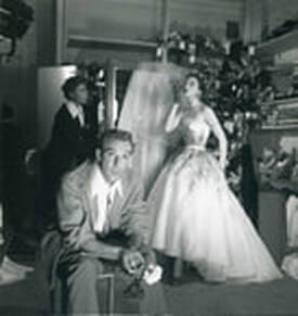 Jacques Fath in his studio with his favourite model Bettina Graziani in the background, 1950