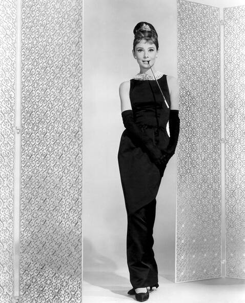 Elegant style icon wardrobe essentials: Audrey Hepburn in black floor length dress designed by Hubert de Givenchy, in film Breakfast at Tiffany's(1961)