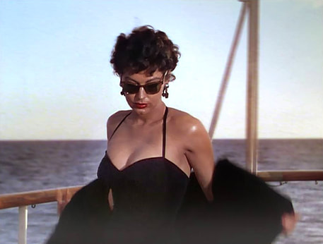 Elegant style icon wardrobe essentials: Ava Gardner in swimwear, a one piece swimsuit in black, in film The Barefoot Contessa(1954)