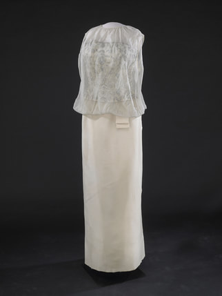 Jackie Kennedy Inauguration gown: an off-white sleeveless gown of silk chiffon over peau d’ange featuring strapless inner bodice embellished with silver silk embroidery and seed pearl beading,  20 Jan 1961, designed and made by Ethel Frankau of Bergdorf Custom Salon based on Jackie’s own sketches and suggestions.