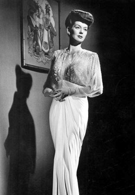 Rosalind Russell in film What A Woman, wearing a gown designed by Travis Banton, 1943.