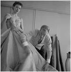 Jacques Fath in his studio with his favourite model Bettina Graziani in the background, 1950