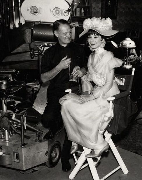 Hepburn with cinematographer Harry Stradling on the set of My Fair Lady (1964)