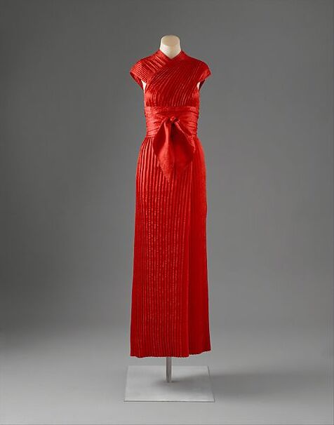 Red pleated silk column evening dress with obi, designed by Claire McCardell for Townley Frocks, 1950, Gift of Irving Drought Harris, in memory of Claire McCardell Harris to the Met, New York, 1958. Copyright Metropolitan Museum of Art