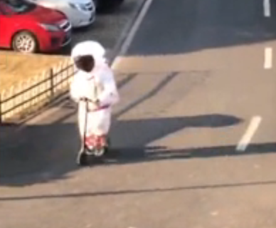 A young chinese boy wearing astronaut costume to go out against the coronavirus